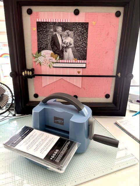 Picture of a Scrapbook page of a wedding photo of myself and husband Neil in Pinks displayed on a Creative Memories Frame,. Also feature a Boho Blue Mini Scrao Cut & Emboss Machine